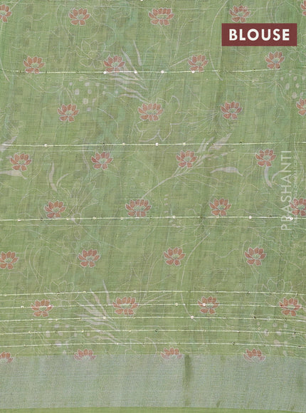 Linen cotton saree light green with allover floral prints & sequin work and silver zari woven border