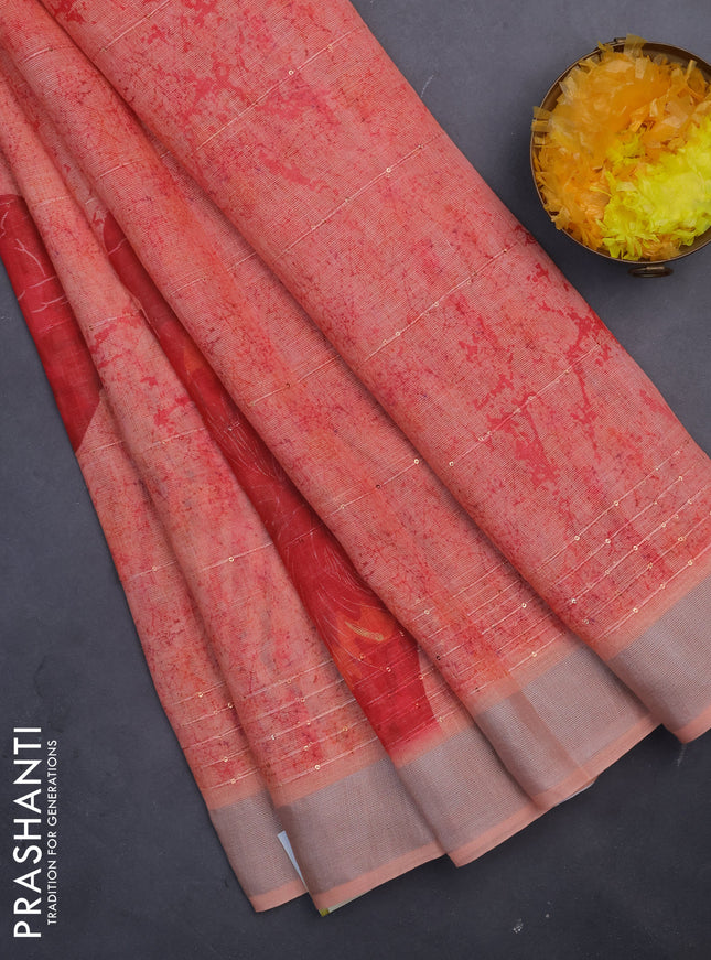 Linen cotton saree pale orange with allover prints & sequin work and silver zari woven border