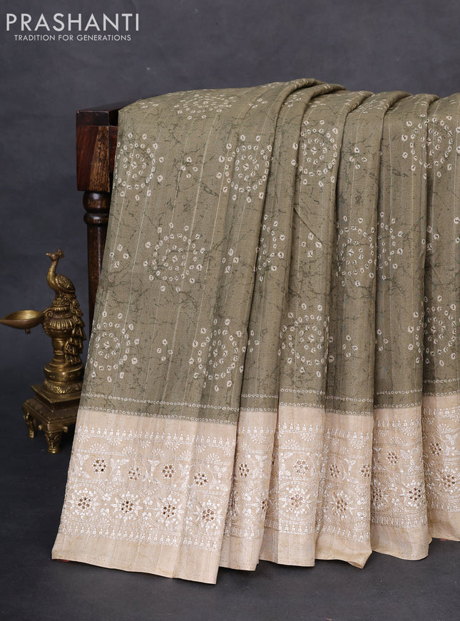 Semi tussar saree sap green shade and beige with allover bandhani prints and embroidery cut work border