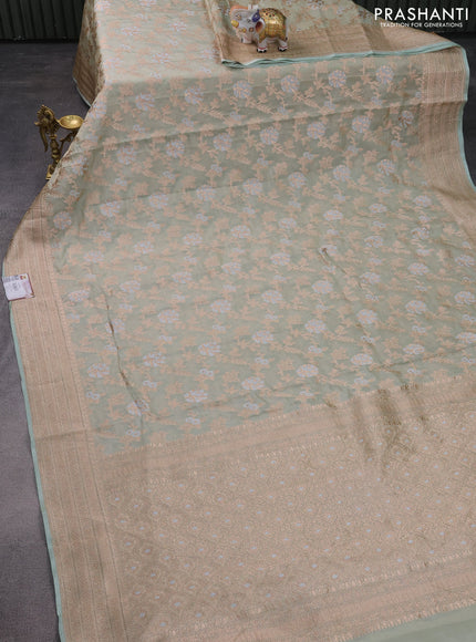 Banarasi tissue silk saree pastel green shade with allover thread & zari woven floral weaves and zari woven border