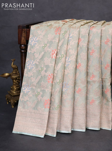 Banarasi tissue silk saree pastel green shade with allover thread & zari woven floral weaves and zari woven border