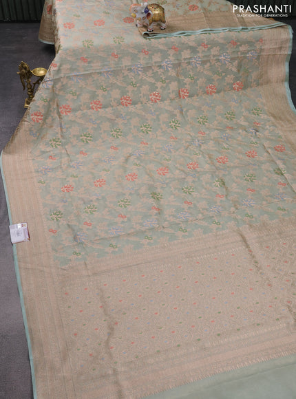 Banarasi tissue silk saree pastel green shade with allover thread & zari woven floral weaves and zari woven border