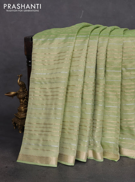 Tissue silk saree light green with allover silver & gold zari weaves and zari woven border