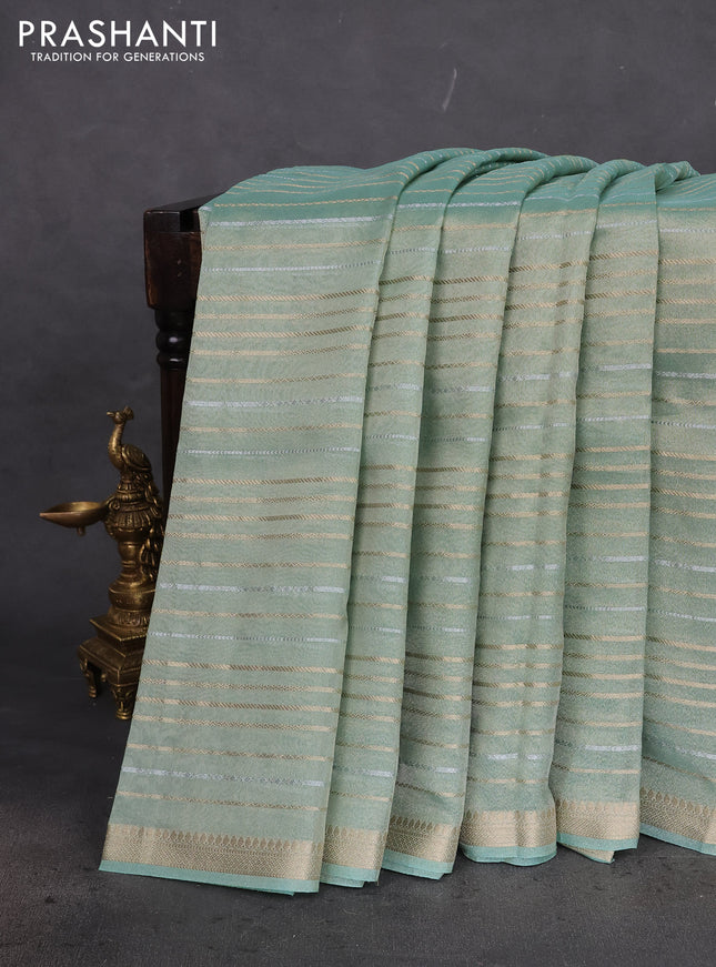 Tissue silk saree pastel green shade with allover silver & gold zari weaves and zari woven border