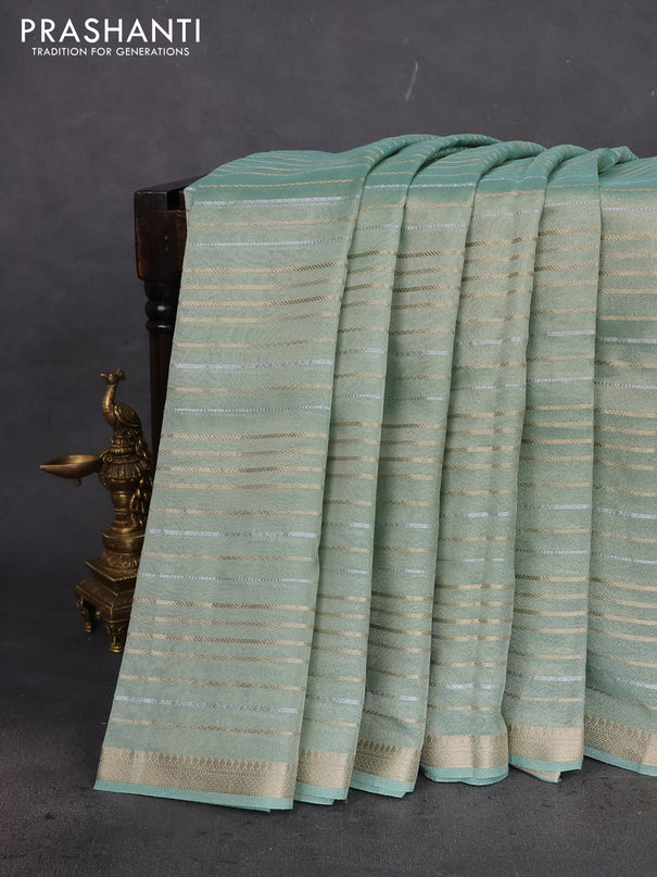 Tissue silk saree pastel green shade with allover silver & gold zari weaves and zari woven border