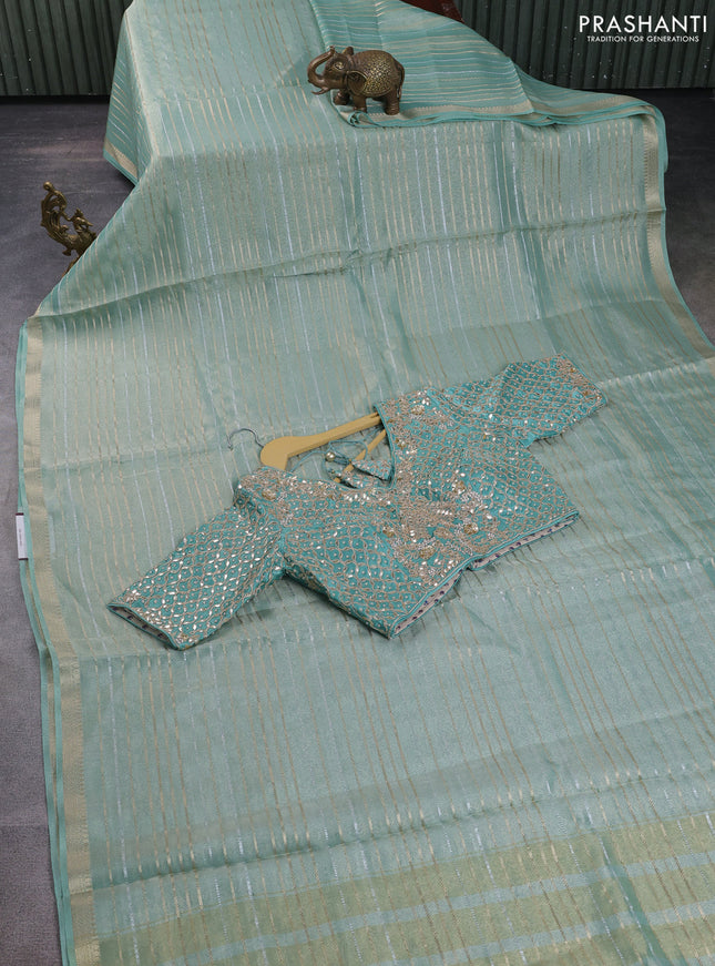 Tissue silk saree pastel green shade with allover silver & gold zari weaves and zari woven border
