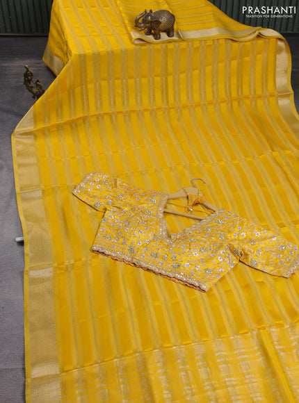 Organza saree yellow with allover zari stripe pattern and zari woven border