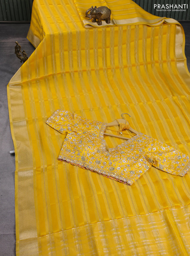 Organza saree yellow with allover zari stripe pattern and zari woven border