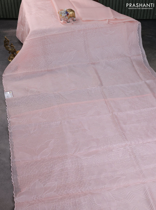 Pure organza silk saree mild peach with allover embroidery and scallop border