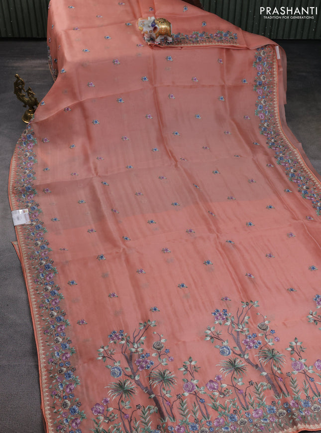 Pure organza silk saree peach orange with allover embroidery buttas and floral embroidery border