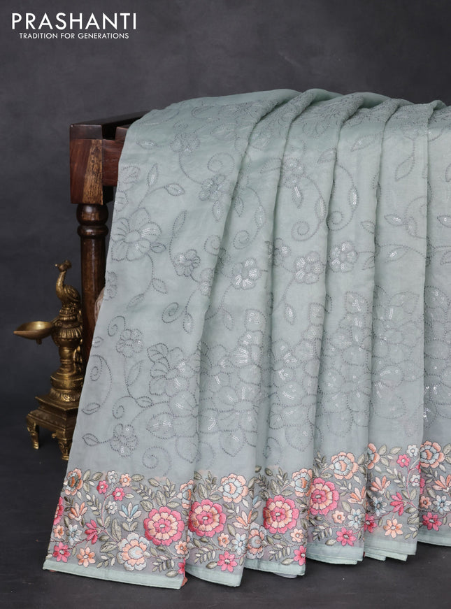 Pure organza silk saree pastel blue shade with allover embroidery and floral embroidery border