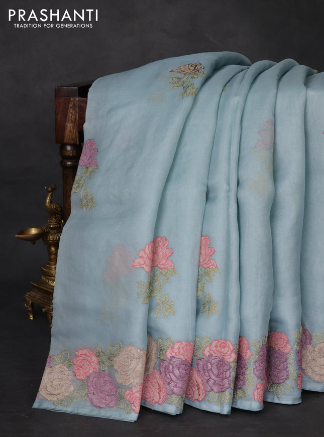 Pure organza silk saree pastel blue with floral embroidery buttas and floral embroidery border