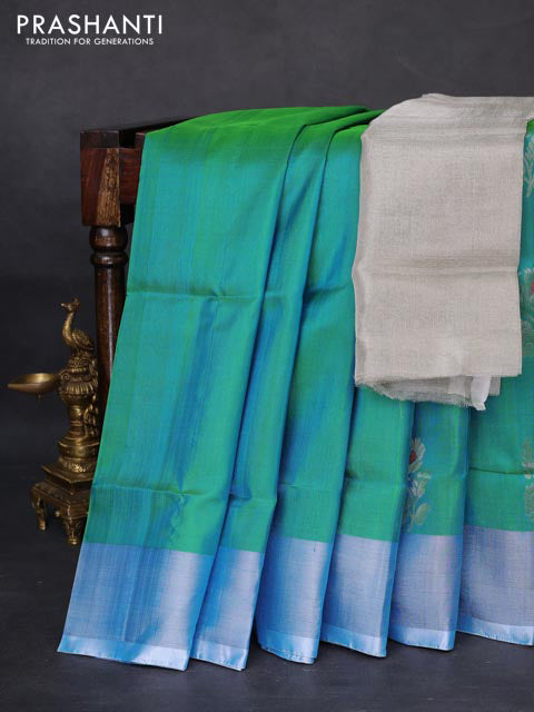 Pure uppada silk saree dual shade of teal blue with silver zari woven floral buttas and silver zari woven border