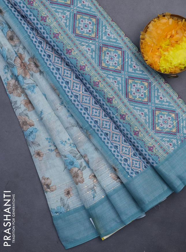 Linen cotton saree teal blue shade with floral prints & sequin work and silver zari woven border