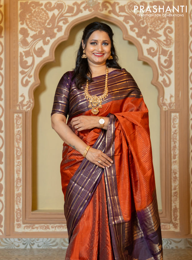 Pure soft silk saree rust and purple with allover zari weaves and long rich zari border