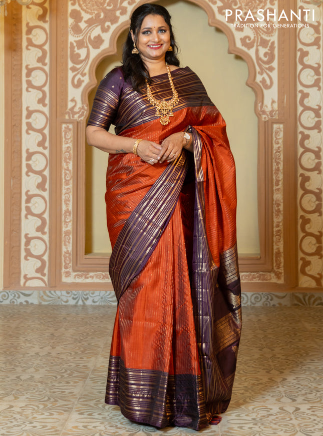 Pure soft silk saree rust and purple with allover zari weaves and long rich zari border