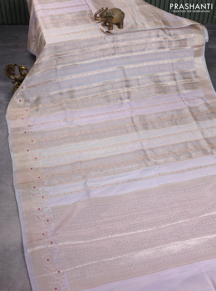 Banarasi tissue semi silk saree pastel grey and mild lavnder with allover zari weaves and zari woven floral border