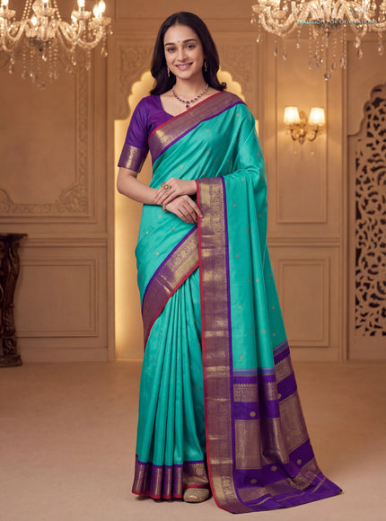 Pure kanchipuram silk saree dual shade of teal bluish green and violet with zari woven buttas and rich zari woven korvai border