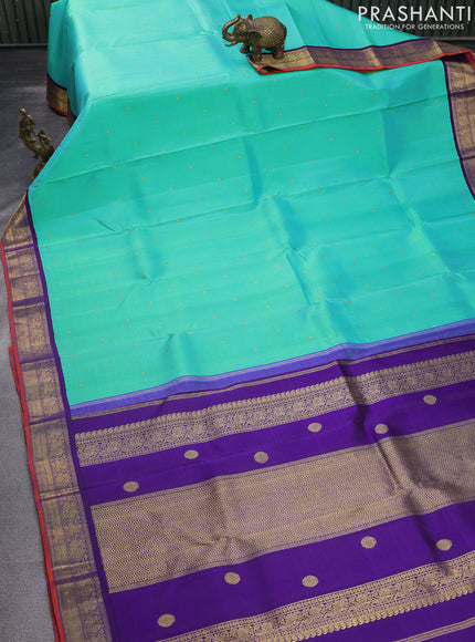 Pure kanchipuram silk saree dual shade of teal bluish green and violet with zari woven buttas and rich zari woven korvai border