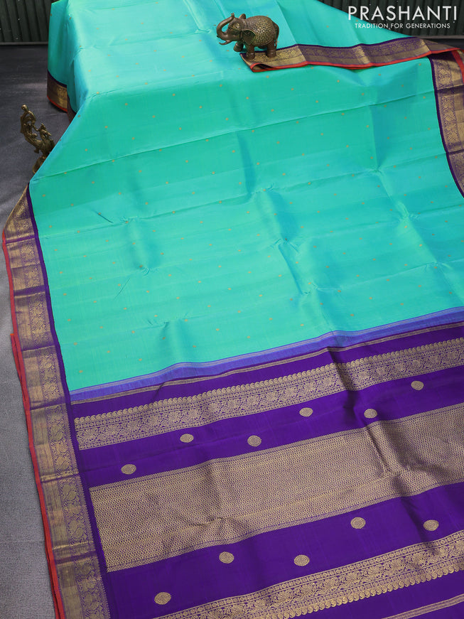 Pure kanchipuram silk saree dual shade of teal bluish green and violet with zari woven buttas and rich zari woven korvai border