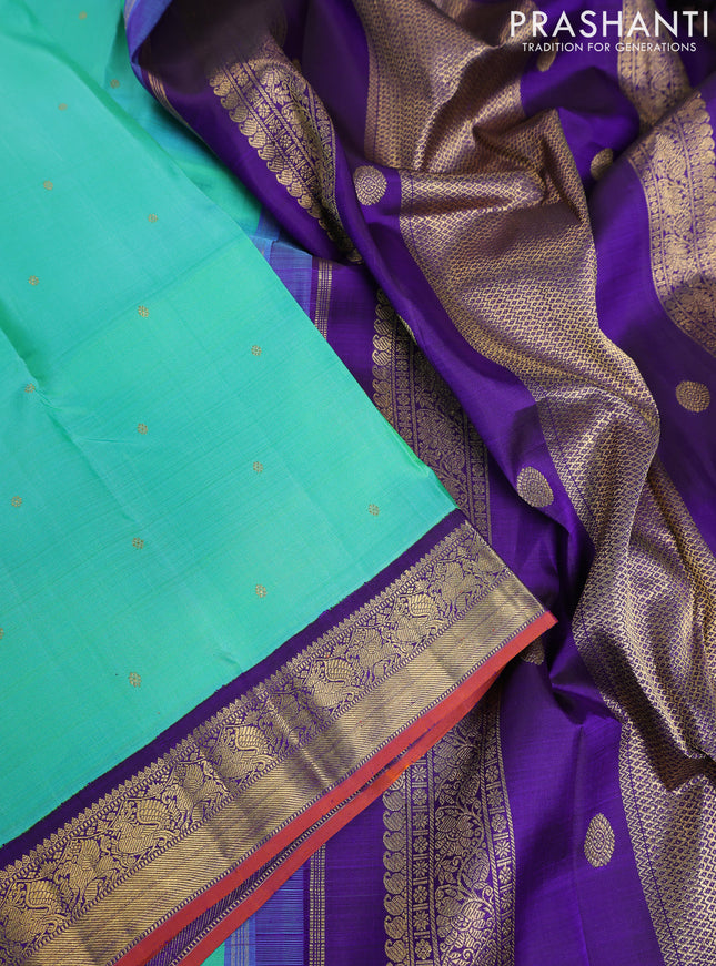 Pure kanchipuram silk saree dual shade of teal bluish green and violet with zari woven buttas and rich zari woven korvai border