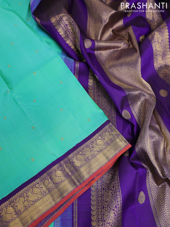 Pure kanchipuram silk saree dual shade of teal bluish green and violet with zari woven buttas and rich zari woven korvai border