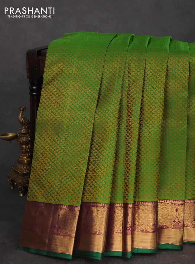 Pure kanchipuram silk saree green and purple with allover paisley self emboss and floral zari woven border