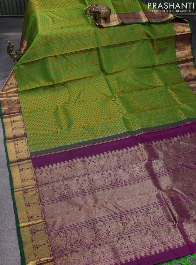 Pure kanchipuram silk saree green and purple with allover paisley self emboss and floral zari woven border