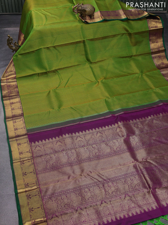 Pure kanchipuram silk saree green and purple with allover paisley self emboss and floral zari woven border