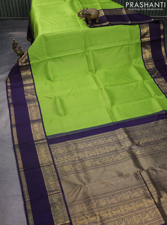 Pure kanchipuram silk saree light green and deep jamun with allover zari woven lakshadeepam pattern and rich zari woven simple border