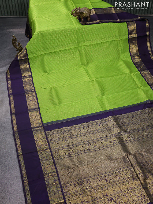 Pure kanchipuram silk saree light green and deep jamun with allover zari woven lakshadeepam pattern and rich zari woven simple border