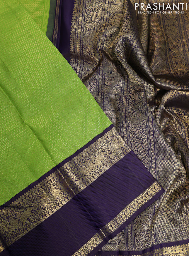 Pure kanchipuram silk saree light green and deep jamun with allover zari woven lakshadeepam pattern and rich zari woven simple border