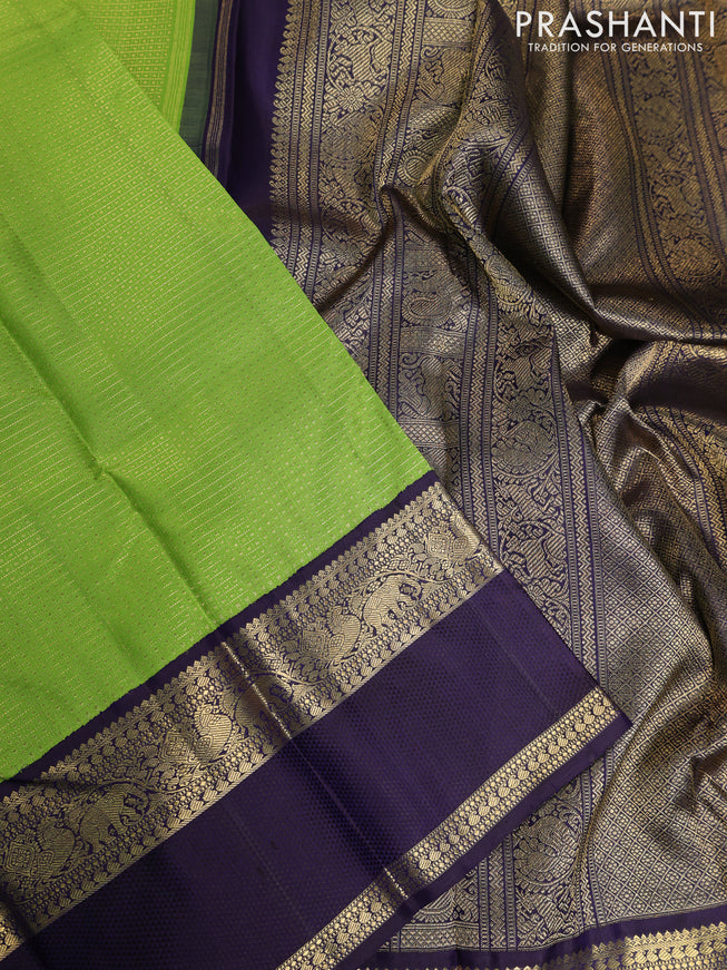 Pure kanchipuram silk saree light green and deep jamun with allover zari woven lakshadeepam pattern and rich zari woven simple border