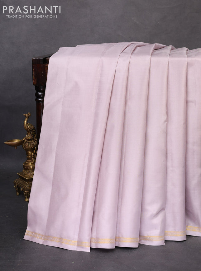 Pure kanchipuram silk saree pastel grey and bottle green with plain body and small zari woven simple border