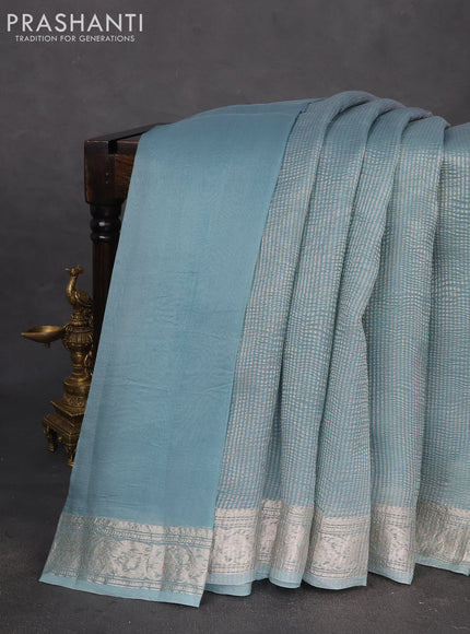 Pure organza partly silk saree pastel blue and grey with allover silver zari weaves and silver zari woven border