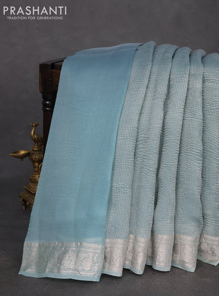 Pure organza partly silk saree grey and pastel blue with allover silver zari weaves and silver zari woven border