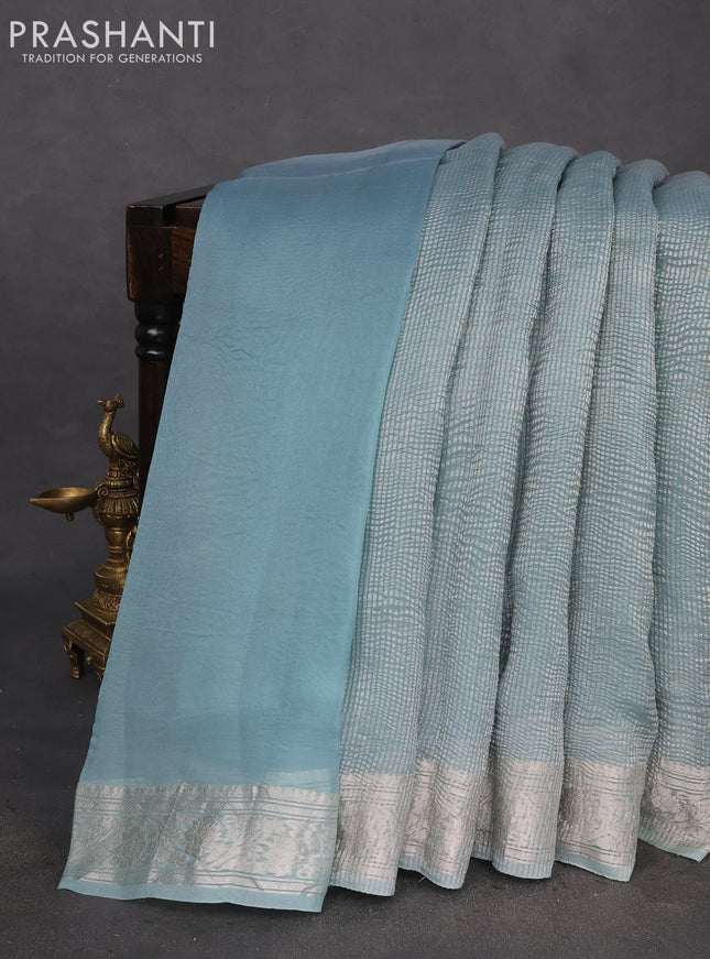 Pure organza partly silk saree grey and pastel blue with allover silver zari weaves and silver zari woven border