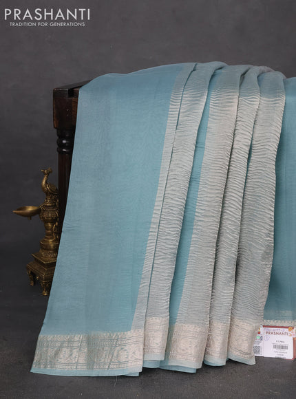 Pure organza partly silk saree grey and pastel blue with silver zari stripe pattern and silver zari woven border