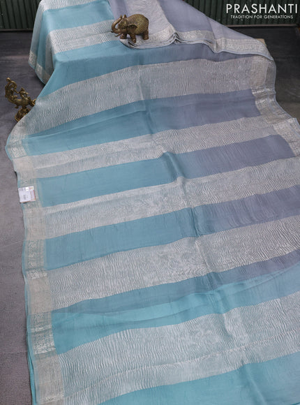 Pure organza partly silk saree grey and pastel blue with silver zari stripe pattern and silver zari woven border