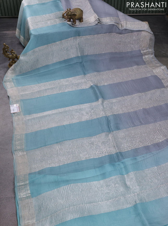 Pure organza partly silk saree grey and pastel blue with silver zari stripe pattern and silver zari woven border