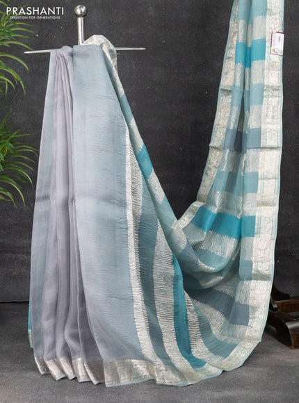 Pure organza partly silk saree pastel blue with allover silver zari weaves and silver zari woven border