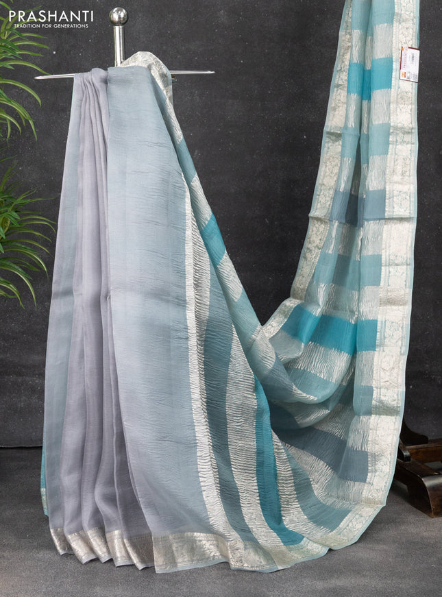 Pure organza partly silk saree pastel blue with allover silver zari weaves and silver zari woven border
