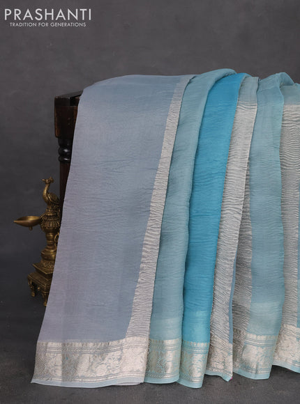 Pure organza partly silk saree pastel blue with allover silver zari weaves and silver zari woven border