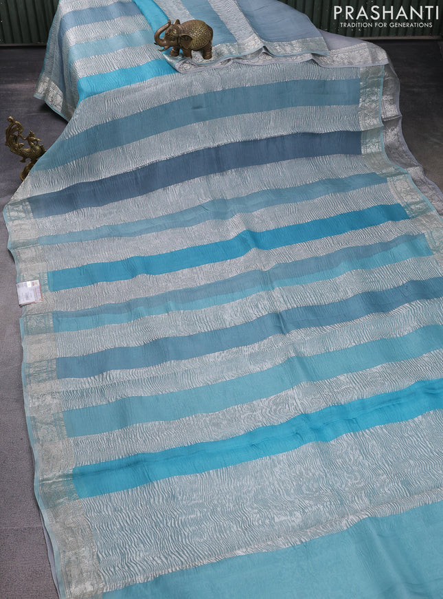 Pure organza partly silk saree pastel blue with allover silver zari weaves and silver zari woven border