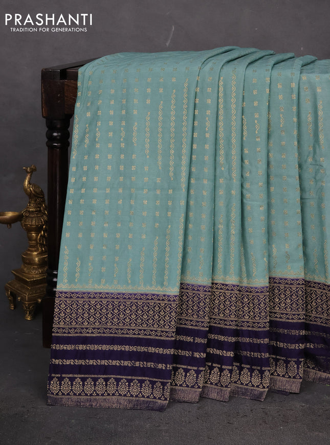Banarasi semi crepe saree pastel green and navy blue with allover zari woven butta weaves and zari woven border