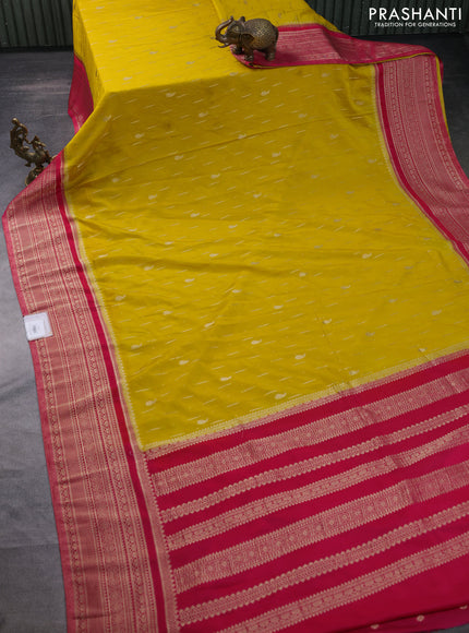 Banarasi semi crepe saree yellow and pink with allover zari woven butta weaves and long zari woven border
