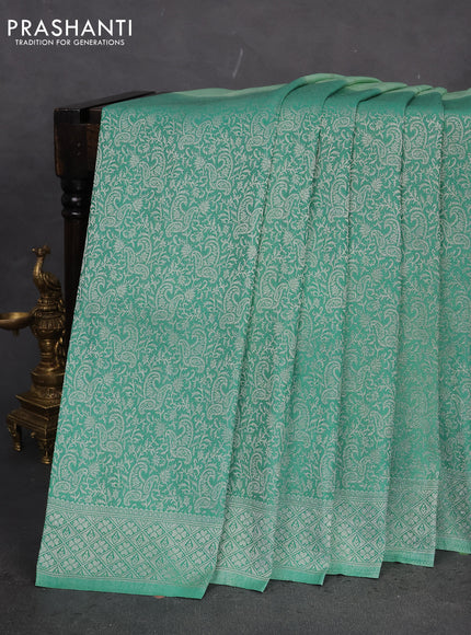 Banarasi semi crepe saree teal green shade with allover woven buttas and long silver zari woven border