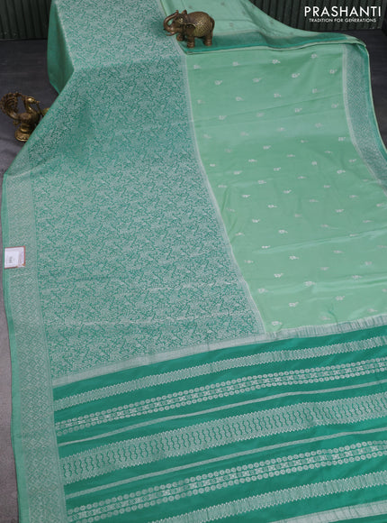 Banarasi semi crepe saree teal green shade with allover woven buttas and long silver zari woven border