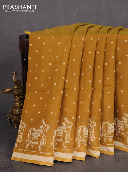 Semi tussar saree dark mustard with allover polka dot weaves and patola weaving pallu
