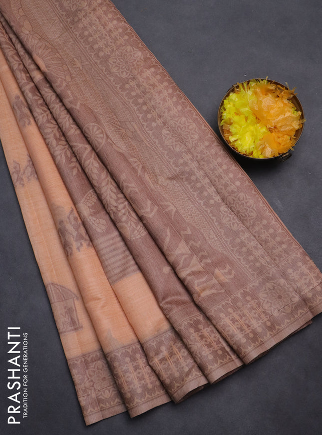 Semi jute silk saree pale orange and brown with thread woven warli buttas and warli design weaving pallu